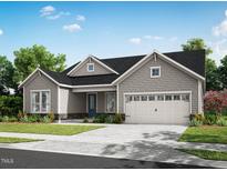 Charming one-story home with gray shingle siding, gabled roof, and a two-car garage at 36 Firefly Ln, Fuquay Varina, NC 27526