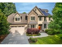 Attractive two-story brick home with stone accents, solar panels, and a well-manicured lawn at 429 Carolina Cir, Durham, NC 27707