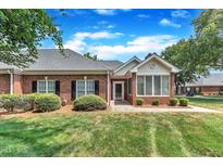 Charming brick home featuring well-manicured landscaping and inviting entrance at 4622 Ludwell Branch Ct, Raleigh, NC 27612