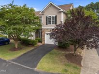 Charming townhome featuring a stone facade, attached garage, and well-maintained landscaping at 5515 South Roxboro # 32, Durham, NC 27713