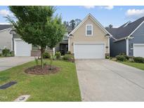 Charming single-Gathering home featuring a well-maintained lawn and attached two-car garage at 605 Smallwood Dr, Durham, NC 27703