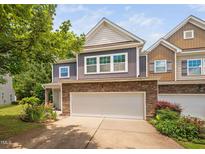 Charming townhouse with stone accents, attached garage, and manicured landscaping at 809 Davidson Point Rd, Cary, NC 27513