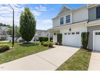 Charming townhome with an attached one car garage and a manicured front lawn at 948 Consortium Dr, Raleigh, NC 27603