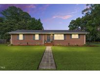 Charming single-story brick home featuring a lush green lawn and a welcoming entryway at 1015 S 1St St, Smithfield, NC 27577