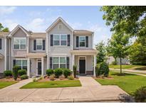 Charming townhome with manicured lawn and traditional architectural details at 102 Harvest Oaks Lane # 38, Durham, NC 27703