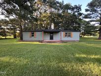 Charming single story home with green siding, wood shutters, and a well-manicured lawn at 10248 Nc-43, Rocky Mount, NC 27801