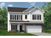Charming two-story home features a brick and white exterior, complemented by a well-manicured lawn and lush landscaping at 108 Freedom Heights Ln # 147, Smithfield, NC 27577
