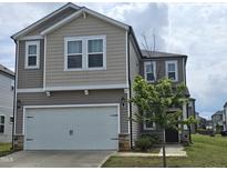 Charming two-story home with a two-car garage and landscaped front yard at 112 Wilbur Lake Dr, Fuquay Varina, NC 27526