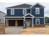 New construction home with blue siding, a garage and covered front porch at 1233 Whitespire Way, Zebulon, NC 27597