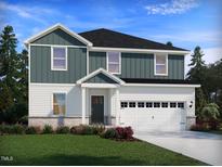 Charming two-story home featuring a two-car garage, well-manicured lawn, and inviting covered entry at 1233 Whitespire Way, Zebulon, NC 27597