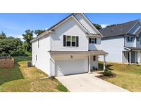 Charming two-story home with white siding, black shutters, attached garage, and well-maintained lawn at 12658 W Hanes Ave, Middlesex, NC 27557
