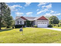 Charming single-story home with a well-manicured lawn and two car garage at 20 Ingate Way, Louisburg, NC 27549