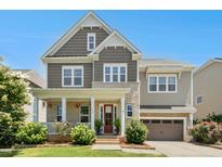 Beautiful two-story home with a brick-and-siding exterior, covered porch, and well-manicured landscaping at 205 Aurora Rd, Hillsborough, NC 27278