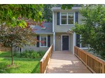 Charming home featuring a wooden walkway leading to the front door and dormer windows at 2222 Pathway Dr, Chapel Hill, NC 27516