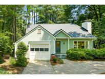 Charming single-story home with a tidy front lawn, attached garage, and fresh green paint at 2504 W Club Blvd, Durham, NC 27705