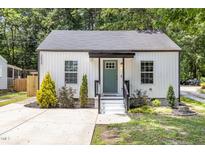 Charming home featuring a well maintained lawn, a cozy porch, and a modern white exterior at 3649 Guess Rd, Durham, NC 27705