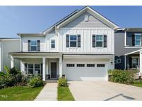 Charming two-story home with white siding, a covered porch, and a two-car garage at 365 Jorpaul Dr, Wake Forest, NC 27587