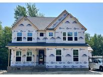 New two-story home with brick foundation and large windows during the construction phase at 386 Rising Star Dr, Clayton, NC 27520