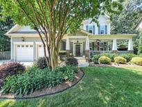 Charming two-story home featuring a welcoming front porch and a well-manicured lawn with mature landscaping at 4416 Brighton Ridge Dr, Apex, NC 27539