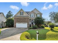 Charming two-story home with a brick facade, attached two-car garage, and beautifully landscaped front yard at 456 Majestic Oak Dr, Garner, NC 27529