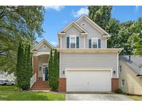 Charming two-story home with gray siding, brick accents, and a well-manicured front yard at 5301 Denmead Way, Raleigh, NC 27613