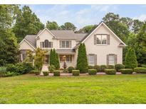 Charming two-story home with landscaped yard, painted brick, mature trees, and inviting curb appeal at 602 Preston Village Way, Cary, NC 27519
