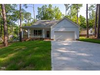 Charming single-Gathering home with a covered porch and well-maintained front yard at 6069 Jones Cir, Sanford, NC 27332