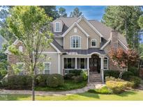 Charming two-story home with stone accents, manicured lawn, and a welcoming front porch at 633 Rolling Springs Dr, Cary, NC 27519