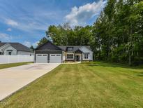 Charming single-Gathering home with a well-manicured lawn and a three-car garage at 710 Country Rd, Middlesex, NC 27557