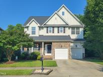 Charming two-story home features a well-manicured lawn, stone accents and a two-car garage at 7502 Hedfield Way, Durham, NC 27713