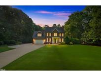 Stunning two-story brick home with manicured lawn and attached garage at 7713 Summercrest Dr, Apex, NC 27539