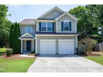 Charming two-story home features a two-car garage and beautiful landscaping at 102 Fallon Ct, Apex, NC 27539