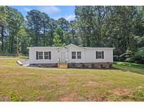 Charming single-story home featuring a welcoming front porch and landscaped yard at 1065 Shuford Rd, Wake Forest, NC 27587