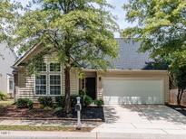 Charming one-story home featuring a well-manicured front yard and an attached two-car garage at 1103 Mallory Ln, Durham, NC 27713