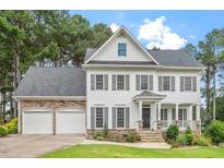 Charming two-story home with a manicured lawn and a two-car garage at 1120 Colonial Club Rd, Wake Forest, NC 27587
