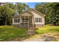 Charming single-Gathering home featuring a welcoming front porch, well-maintained lawn, and classic siding at 116 Justice St, Chapel Hill, NC 27516