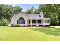 Charming single-story home with a welcoming front porch and well-maintained lawn at 117 S Woodstone Dr, Archer Lodge, NC 27527