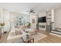 Bright living room with a comfortable sectional sofa and modern fireplace at 1172 Cottonsprings Dr, Wendell, NC 27591