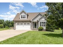 Charming gray two-story home with stone accents, a two-car garage, and a well-manicured front lawn at 14 Water Front Ln, Timberlake, NC 27583