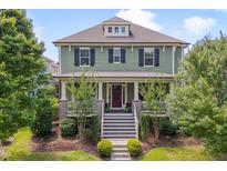 Charming two-story home with inviting front porch, manicured landscaping and stairway leading to the front door at 149 N Serenity Hill Cir, Chapel Hill, NC 27516