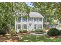 Charming two-story home with gray shutters, landscaped yard, and mature trees at 18 Clearwater Dr, Durham, NC 27707