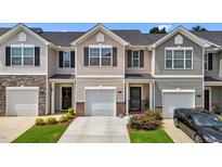Charming townhome with a one car garage, covered entry and landscaped front yard at 1891 Frost Dr, Haw River, NC 27258