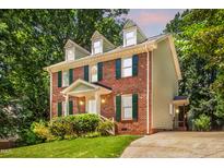 Charming two-story brick home with green shutters and lush landscaping at 212 Heidinger Dr, Cary, NC 27511