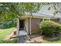 Charming brick home featuring a cozy, covered front entrance and landscaped yard at 2213 Alpine Rd, Durham, NC 27707