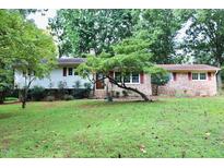 Charming one-story home featuring a well-maintained lawn, brick accents, and a mature tree at 2440 Gardner Holt Rd, Burlington, NC 27215