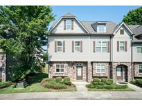 Charming two-story townhome featuring stone accents, neutral siding, and well-maintained landscaping at 2808 Carter Finley Pl, Raleigh, NC 27606