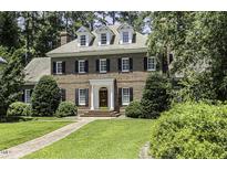 Stately brick home with dormer windows, black shutters, and a well-manicured lawn at 3112 Lake Pointe Trl, Rocky Mount, NC 27804
