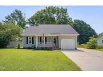 Charming home with a well-manicured lawn, inviting porch, and attached single-car garage at 4140 Willow Haven Ct, Raleigh, NC 27616