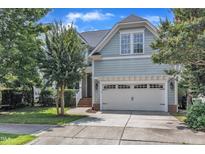 Charming home featuring an attached two-car garage and beautiful landscaping at 500 Chandler Grant Dr, Cary, NC 27519