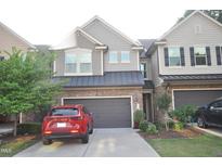 Charming townhome featuring a stone facade, neutral siding, and a convenient attached two-car garage at 536 Rockcastle Dr, Cary, NC 27519
